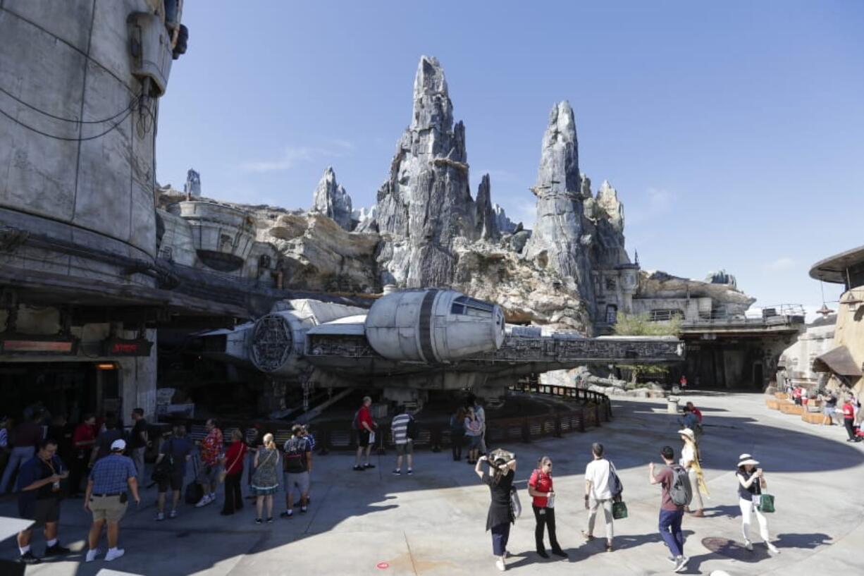 Park visitors walk near the entrance to the Millennium Falcon Smugglers Run ride Tuesday during a preview of the “Star Wars”-themed land, Galaxy’s Edge in Hollywood Studios at Disney World in Lake Buena Vista, Fla. The attraction opened Thursday to park guests.