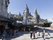 Park visitors walk near the entrance to the Millennium Falcon Smugglers Run ride Tuesday during a preview of the “Star Wars”-themed land, Galaxy’s Edge in Hollywood Studios at Disney World in Lake Buena Vista, Fla. The attraction opened Thursday to park guests.