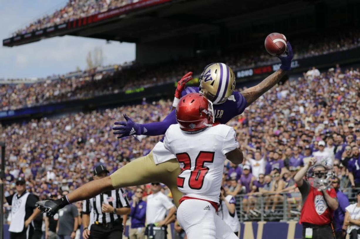 Washington's Aaron Fuller makes a one-handed catch for a touchdown over Eastern Washington's Darreon Moore (26) in the first half of an NCAA college football game Saturday, Aug. 31, 2019, in Seattle.