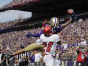 Washington's Aaron Fuller makes a one-handed catch for a touchdown over Eastern Washington's Darreon Moore (26) in the first half of an NCAA college football game Saturday, Aug. 31, 2019, in Seattle.