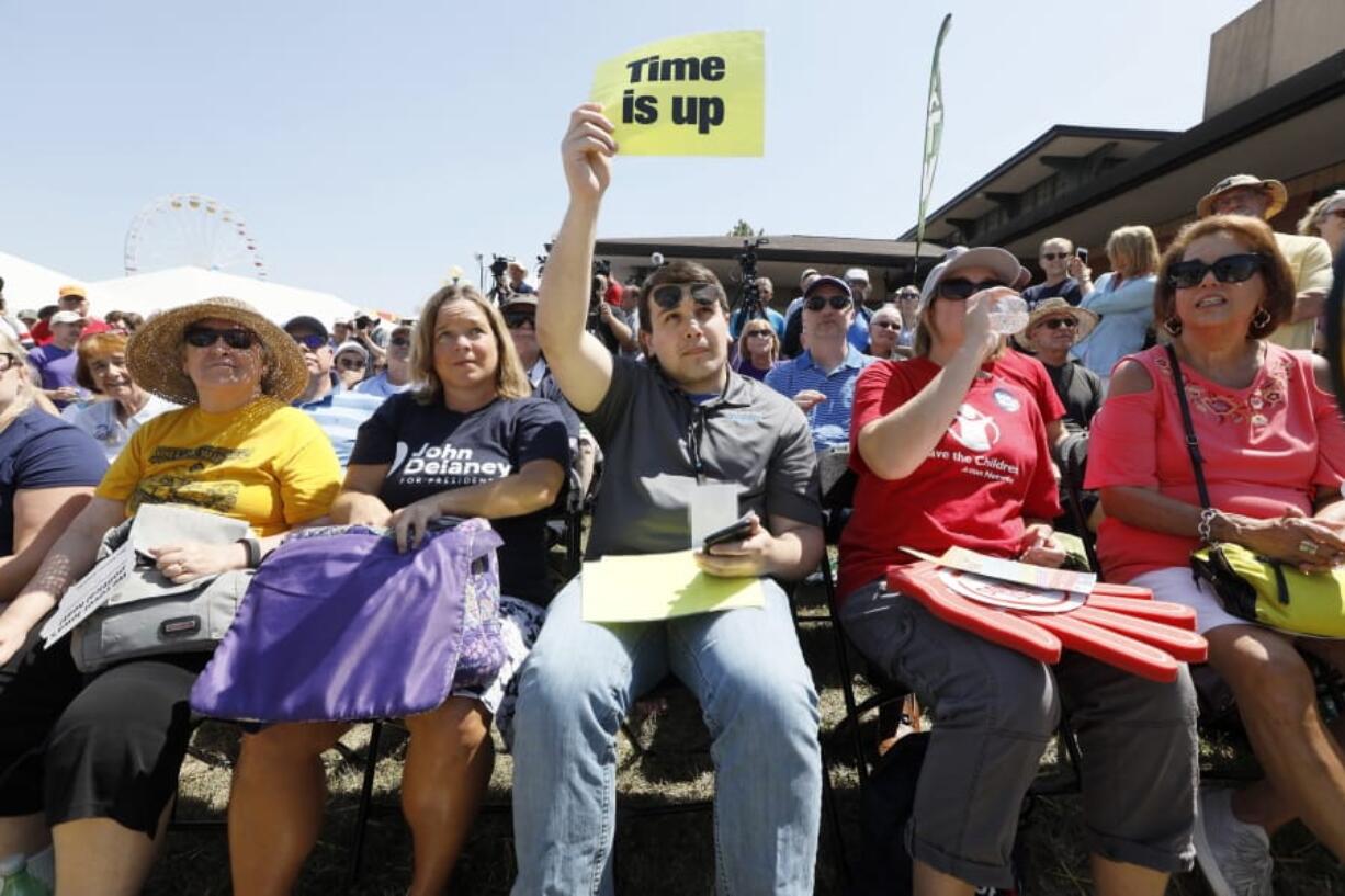 Audience members listens as Democratic presidential candidate former Rep. John Delaney of Maryland, ends his speech at the Des Moines Register Soapbox during a visit to the Iowa State Fair, Friday, Aug. 9, 2019, in Des Moines, Iowa.