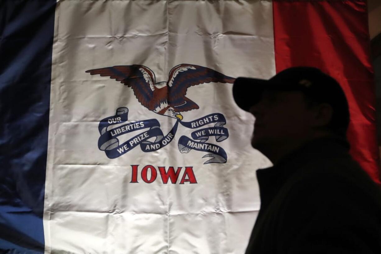 FILE - In this March 8, 2019 file photo, an audience member arrives at a rally for 2020 Democratic presidential candidate at the University of Iowa in Iowa City, Iowa. The Democratic National Committee will recommend scrapping state plans to offer virtual, telephone-based caucuses in 2020 due to security concerns, sources tell The Associated Press on Thursday, Aug. 29, 2019. The final choice whether to allow virtual caucuses in Iowa and Nevada is up to the party’s powerful Rules and Bylaws Committee.