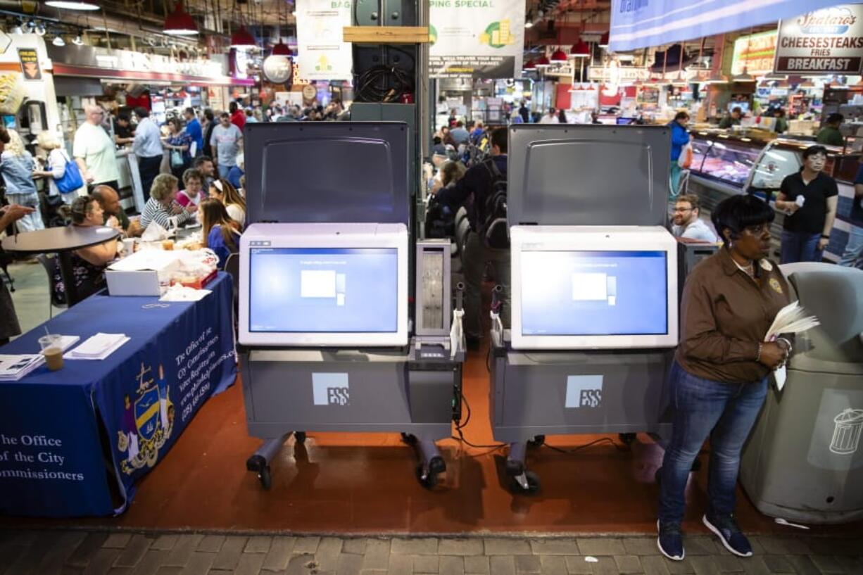 FILE - In this June 13, 2019, file photo, ExpressVote XL voting machines are displayed during a demonstration at the Reading Terminal Market in Philadelphia. More than one in ten voters could vote on paperless voting machines in the 2020 general election, according to a new analysis, leaving their ballots vulnerable to hacking according to a new study.