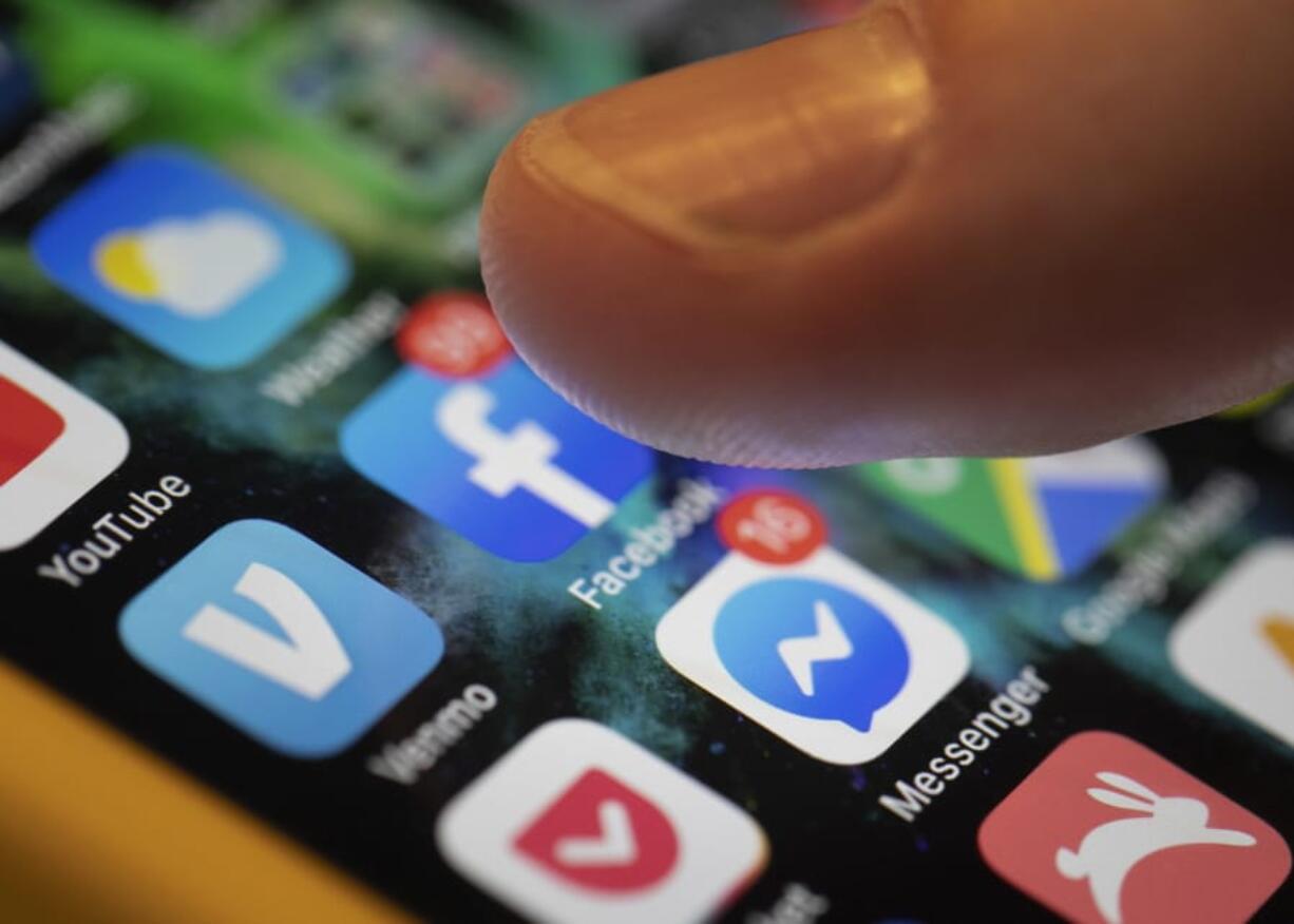 An iPhone displays the apps for Facebook and Messenger on Aug. 11 in New Orleans.