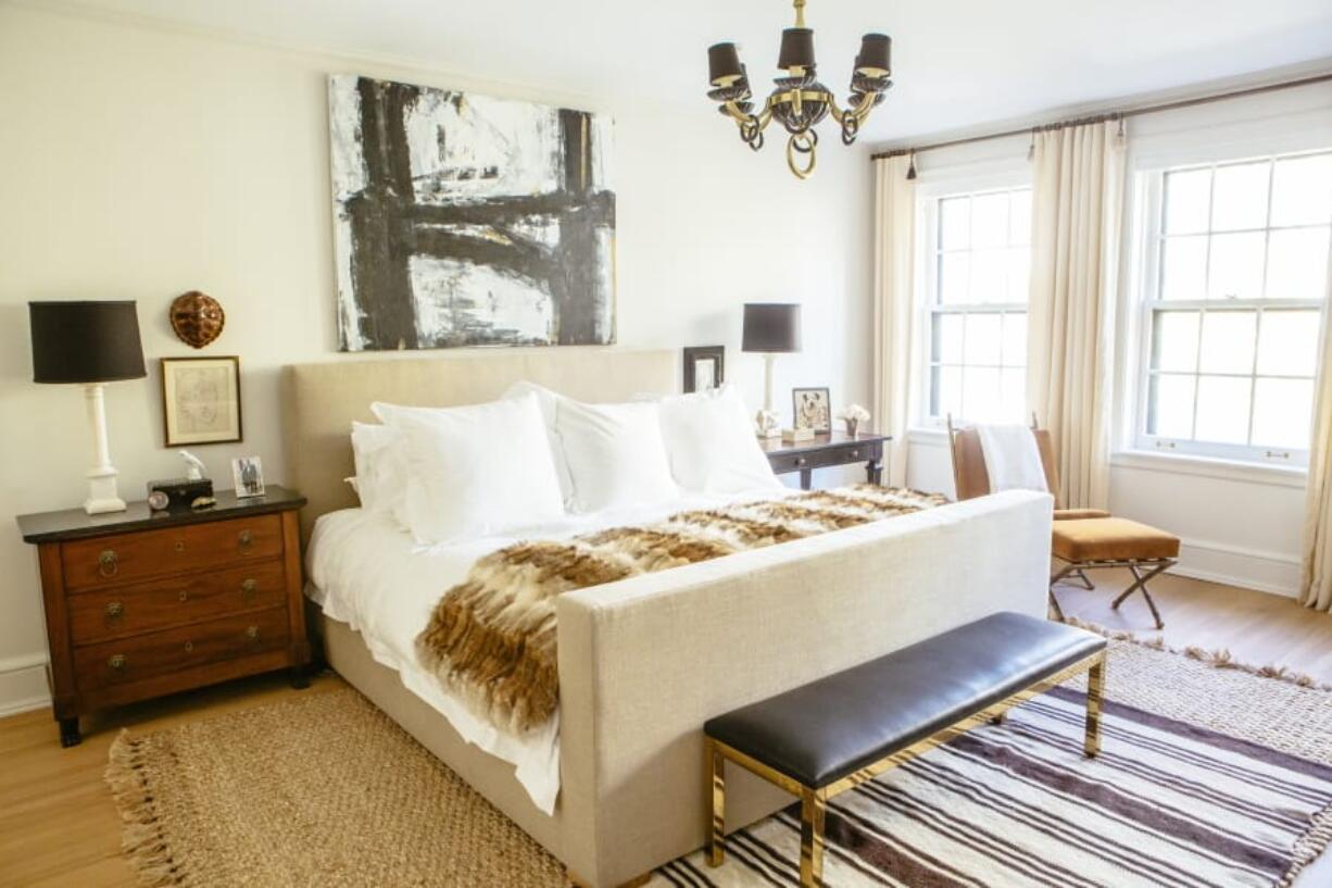 This undated photo shows a master bedroom designed by Lauren Buxbaum Gordon. The natural fiber rug adds warmth and softness around the bed, while a smaller throw rug adds a touch of bold pattern.