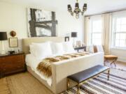 This undated photo shows a master bedroom designed by Lauren Buxbaum Gordon. The natural fiber rug adds warmth and softness around the bed, while a smaller throw rug adds a touch of bold pattern.