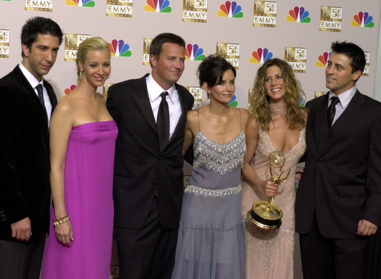 The stars of “Friends,” from left, David Schwimmer, Lisa Kudrow, Matthew Perry, Courteney Cox Arquette, Jennifer Aniston and Matt LeBlanc pose on Sept. 22, 2002, after the show won outstanding comedy series at the 54th Annual Primetime Emmy Awards, at the Shrine Auditorium in Los Angeles.