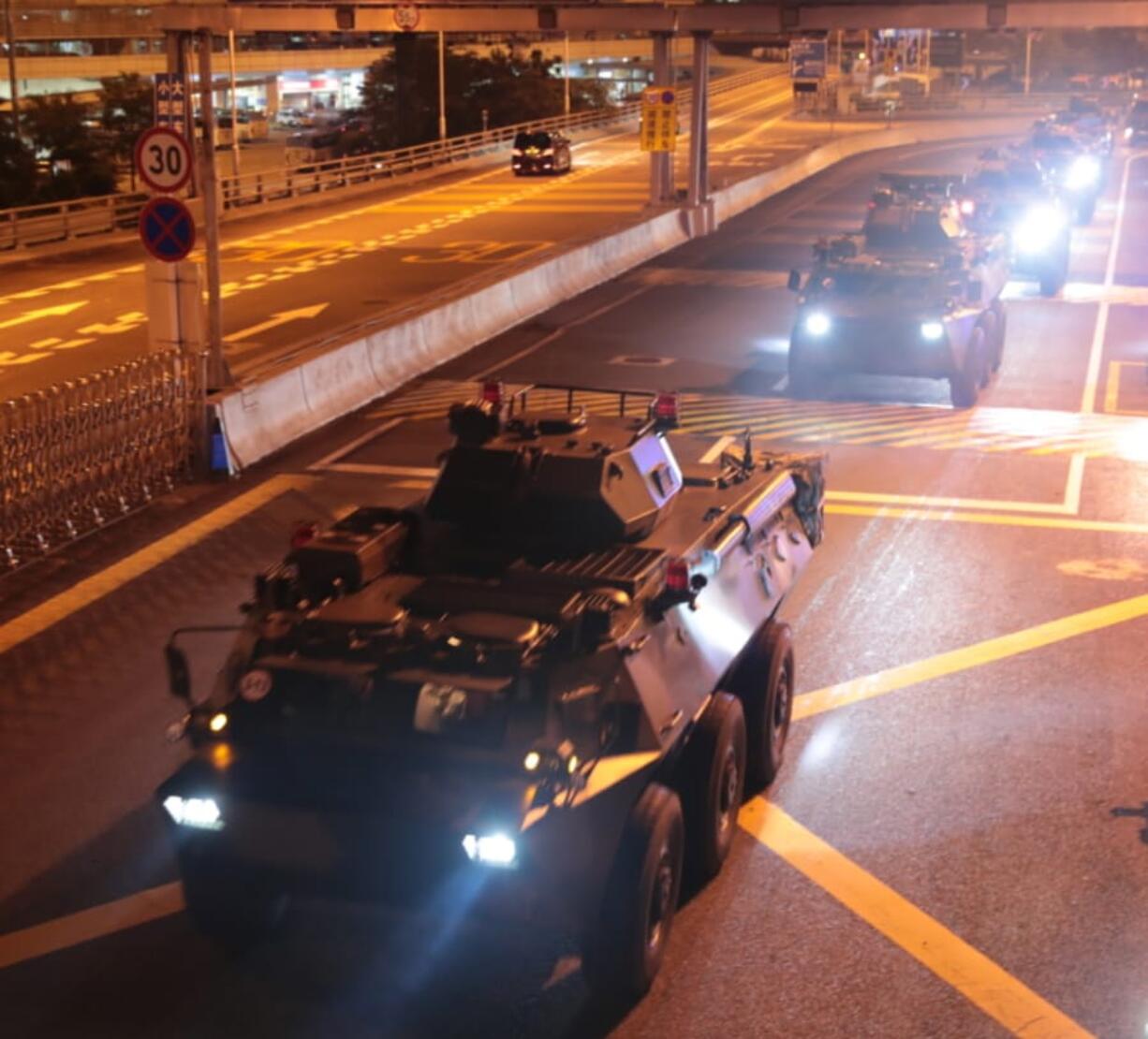 In this photo released by China’s Xinhua News Agency, armored personnel carriers of China’s People’s Liberation Army (PLA) pass through the Huanggang Port border between China and Hong Kong, Thursday, Aug. 29, 2019. Chinese state media has published photos of the country’s Hong Kong-based troops’ armored carriers and a patrol boat undertaking what they call a routine rotation.