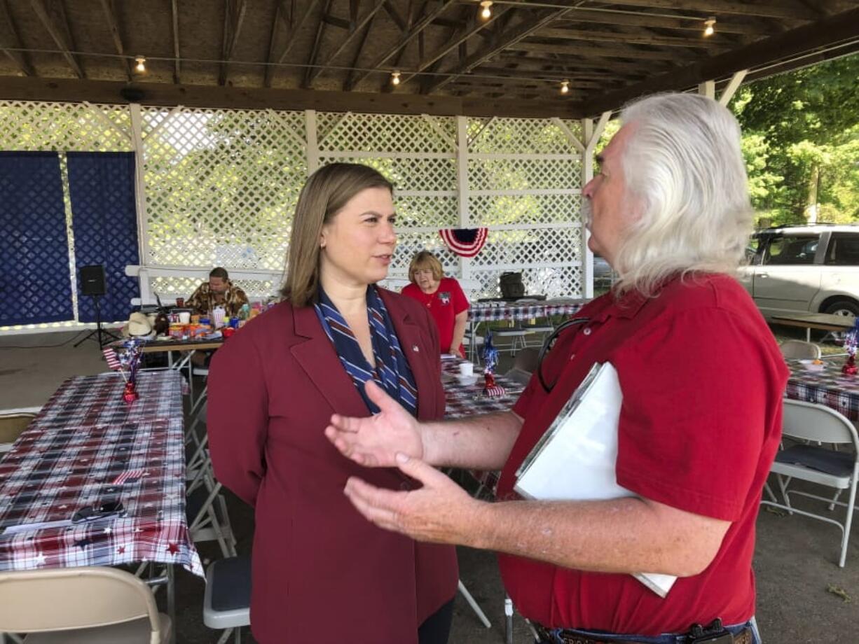 Rep. Elissa Slotkin, D-Mich., talks with a constituent after a veterans event on Friday in Mason, Mich. Slotkin, who defeated a Republican incumbent in 2018, has not backed an impeachment inquiry of President Donald Trump.