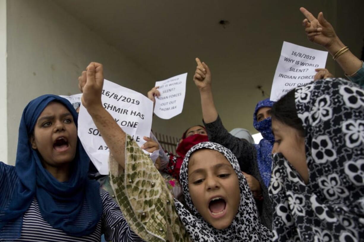 Kashmiri Muslim girls shout pro-freedom slogans during a demonstration after Friday prayers amid curfew like restrictions in Srinagar, India, Friday, Aug. 16, 2019.