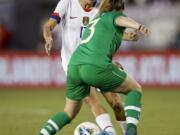 U.S. forward Tobin Heath, left, a member of the Portland Thorns, works the ball around Ireland defender Harriet Scott during the first half of an international friendly on Saturday at Pasadena, Calif.