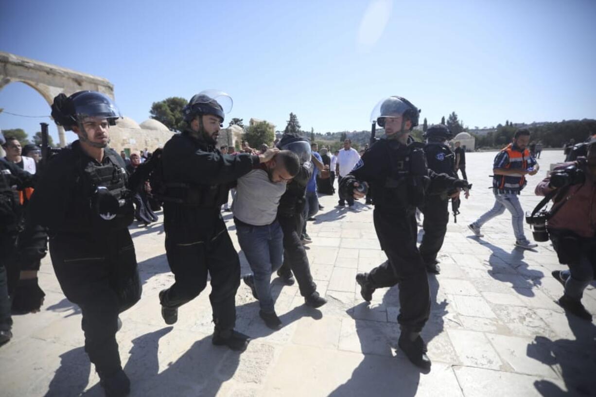 Israeli police arrest a Palestinian worshipper Sunday at al-Aqsa mosque compound in Jerusalem.