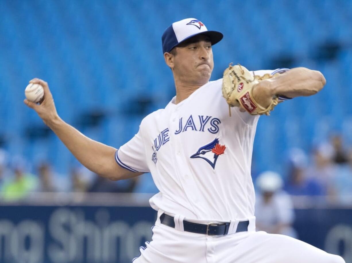 Toronto Blue Jays starting pitcher Jacob Waguespack throws to a Seattle Mariners batter during the first inning of a baseball game Friday, Aug. 16, 2019, in Toronto.