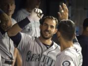 Seattle Mariners’ Austin Nola celebrates in the dugout with teammates after hitting a solo home run during fourth-inning baseball game action against the Toronto Blue Jays in Toronto, Saturday, Aug. 17, 2019.