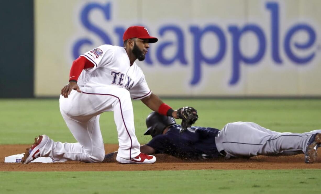 Texas Rangers shortstop Elvis Andrus (1) reaches down to apply the tag on Seattle Mariners’ Dylan Moore who was caught stealing second in the fourth inning of a baseball game in Arlington, Texas, Saturday Aug. 31, 2019.