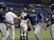 Seattle Mariners' Tom Murphy (2) celebrates with J.P. Crawford (3) and Austin Nola (23) after Murphy hit a three-run home run off Tampa Bay Rays starting pitcher Brendan McKay during the first inning of a baseball game, Monday, Aug. 19, 2019, in St. Petersburg, Fla.