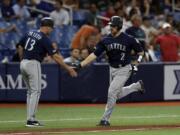 Seattle Mariners’ Tom Murphy (2) shakes hands with third base coach Chris Prieto (13) after Murphy hit a two-run home run off Tampa Bay Rays relief pitcher Jalen Beeks during the sixth inning of a baseball game Tuesday, Aug. 20, 2019, in St. Petersburg, Fla.