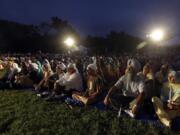 FILE - In this Aug. 5, 2013, file photo hundreds participate in a candlelight vigil at the Sikh Temple of Wisconsin to mark the one-year anniversary of the shooting rampage that left six dead in Oak Creek, Wis. The white supremacist gunman, who wounded five other worshippers and an Oak Creek police officer, killed himself in the parking lot.