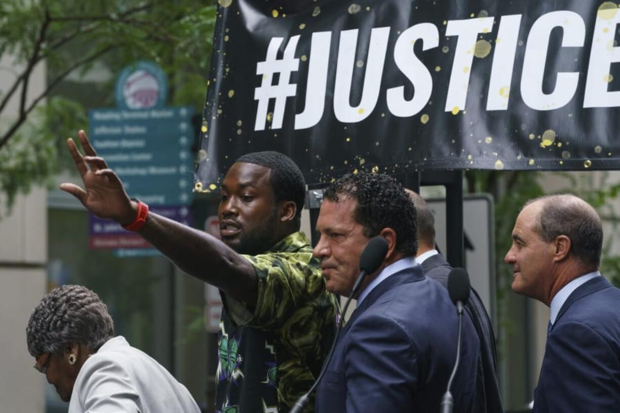 Rapper Meek Mill gestures at the crowd outside the Criminal Justice Center in Center City Philadelphia on Tuesday, Aug. 27, 2019. Mill pleaded guilty to a 2007 misdemeanor gun charge and won’t serve additional time in prison after reaching a plea agreement in a case that’s kept him on probation for most of his adult life.