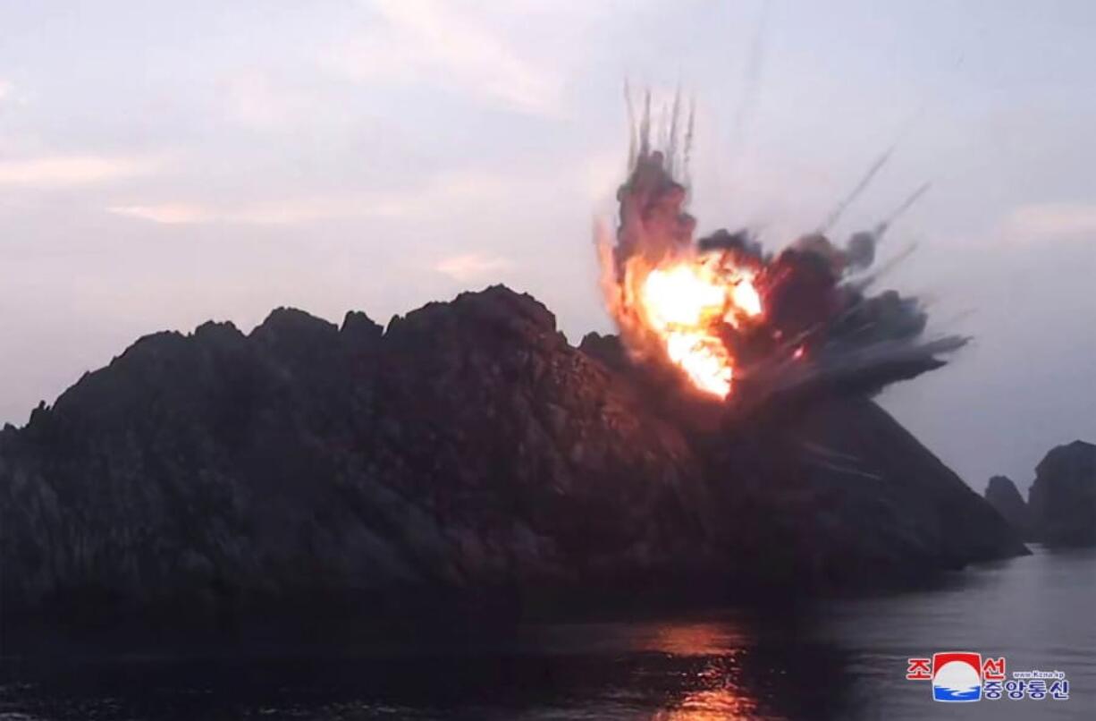 This Tuesday, Aug. 6, 2019, photo provided by the North Korean government shows what it says a new-type tactical guided missile launched from an airfield in the western area of North Korea landing in an islet in waters off the country’s eastern coast. Independent journalists were not given access to cover the event depicted in this image distributed by the North Korean government. The content of this image is as provided and cannot be independently verified. Korean language watermark on image as provided by source reads: “KCNA” which is the abbreviation for Korean Central News Agency.