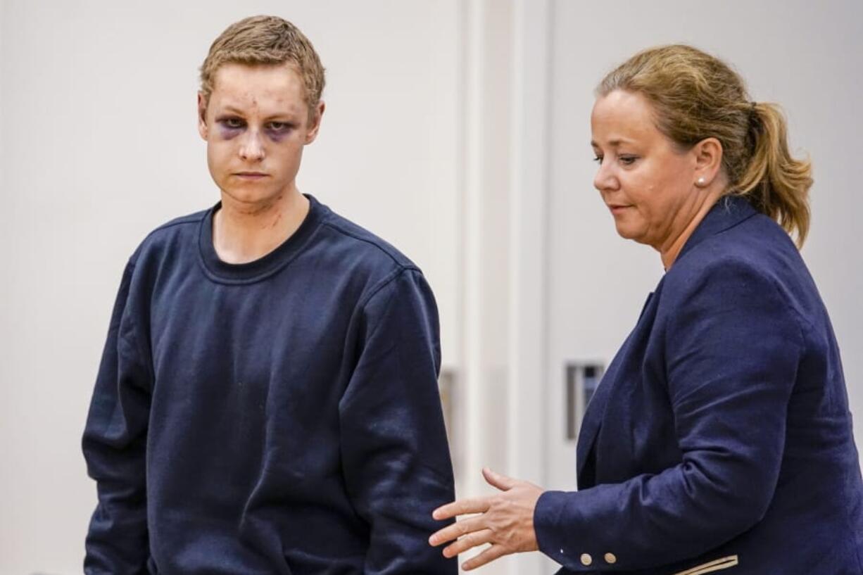 Suspected gunman Philip Manshaus, left and his lawyer Unni Fries attend a court hearing, in Oslo, Norway, Monday, Aug. 12, 2019. A suspected gunman accused of an attempted terrorist attack on an Oslo mosque and separately killing his teenage stepsister “will use his right not to explain himself for now” in a detention hearing, his defense lawyer said Monday.