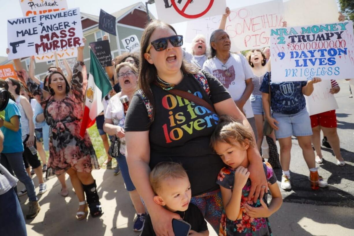 Demonstrators chant as they protest the arrival of President Donald Trump outside Miami Valley Hospital after a mass shooting that occurred in the Oregon District early Sunday morning, Wednesday, Aug. 7, 2019, in Dayton.