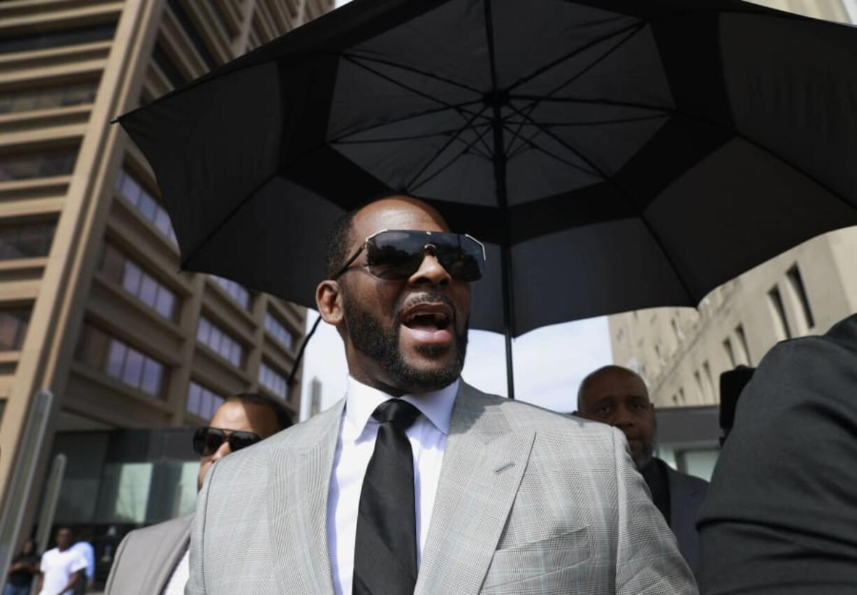 FILE - In this June 6, 2019, file photo, musician R. Kelly leaves the Leighton Criminal Court building in Chicago. Minnesota authorities charged singer R. Kelly on Monday, Aug. 5, 2019, with two counts of prostitution and solicitation involving a girl under 18 in 2001.