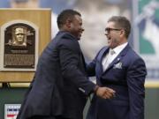 Former Seattle Mariners designated hitter Edgar Martinez, right, is greeted by former teammate and fellow Hall of Famer Ken Griffey Jr. while Martinez was being honored for his recent induction into the Baseball Hall of Fame, before a game between the Mariners and the Tampa Bay Rays on Saturday, in Seattle.