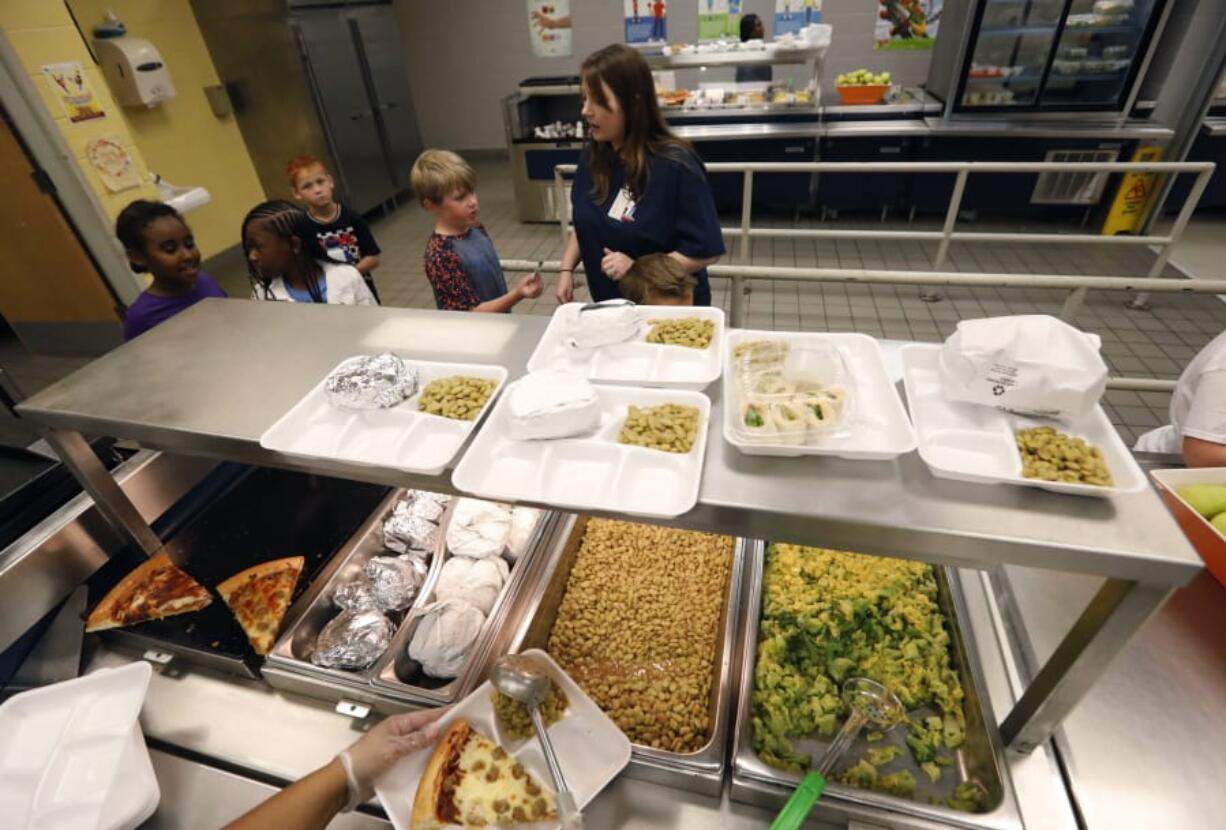 A teacher lines up the students for school-prepared lunches Friday at Madison Crossing Elementary School in Canton, Miss. Rogelio V.