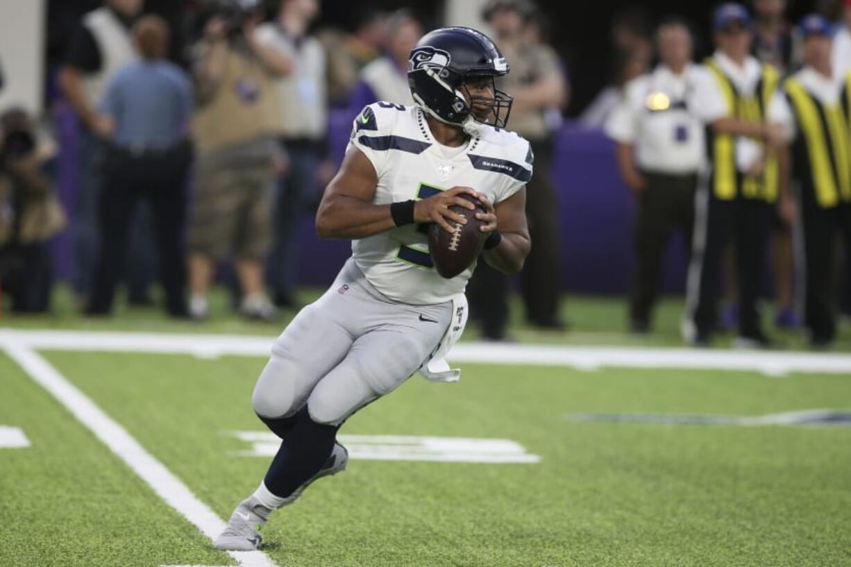 Seattle Seahawks quarterback Russell Wilson throws a pass during the first half of an NFL preseason football game against the Minnesota Vikings, Sunday, Aug. 18, 2019, in Minneapolis.