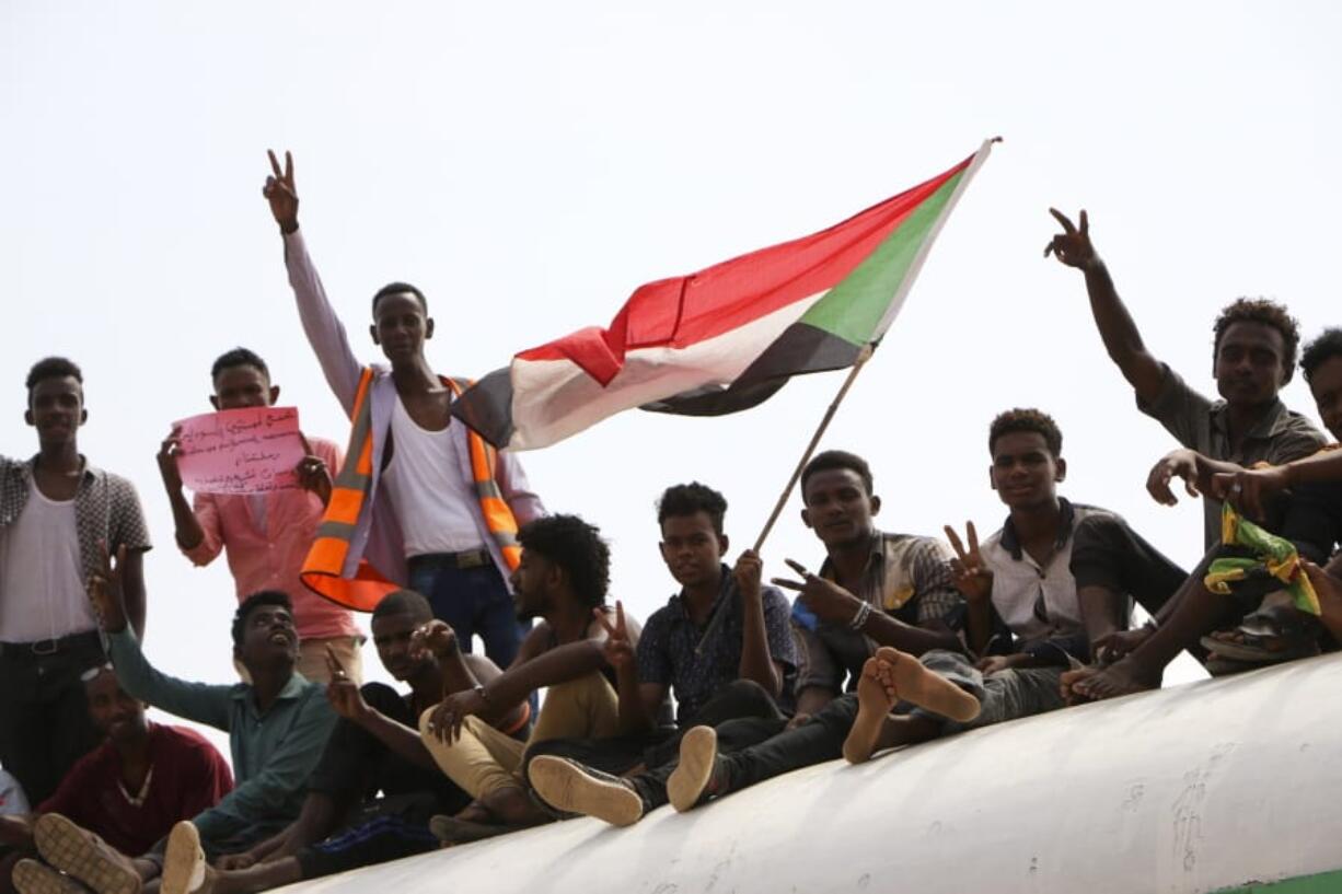 Sudanese pro-democracy supporters celebrate a final power-sharing agreement with the ruling military council Saturday in the capital, Khartoum.