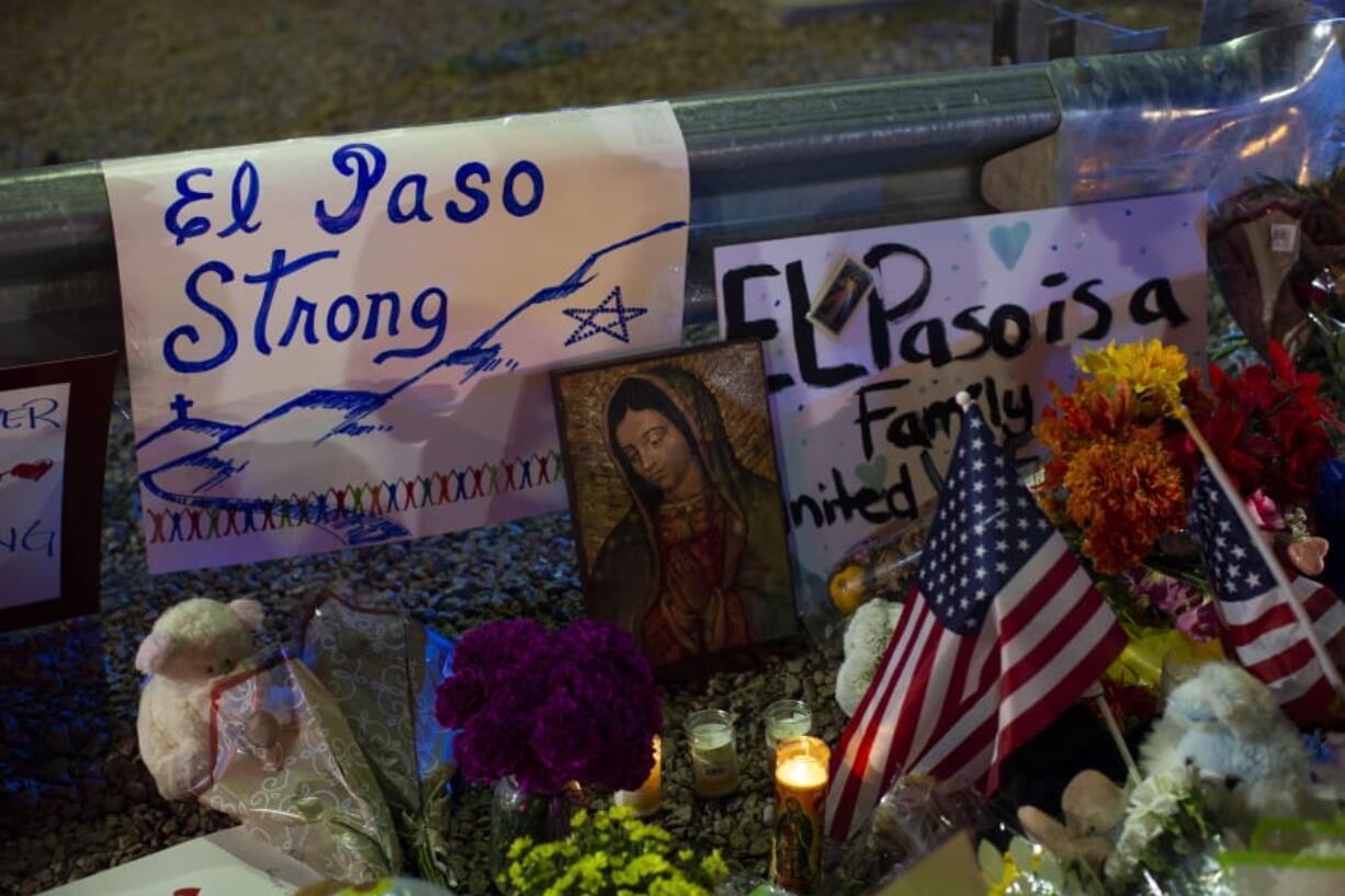 A Virgin Mary painting, flags and flowers adorn a makeshift memorial for the victims of Saturday’s mass shooting at a shopping complex in El Paso, Texas, Sunday, Aug. 4, 2019.