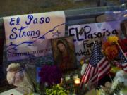 A Virgin Mary painting, flags and flowers adorn a makeshift memorial for the victims of Saturday’s mass shooting at a shopping complex in El Paso, Texas, Sunday, Aug. 4, 2019.