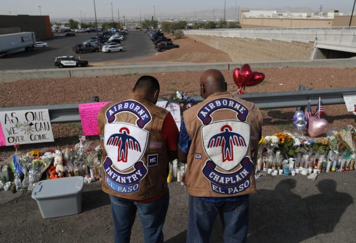 People pray a makeshift memorial for victims of a mass shooting at a shopping complex Monday, Aug. 5, 2019, in El Paso, Texas.