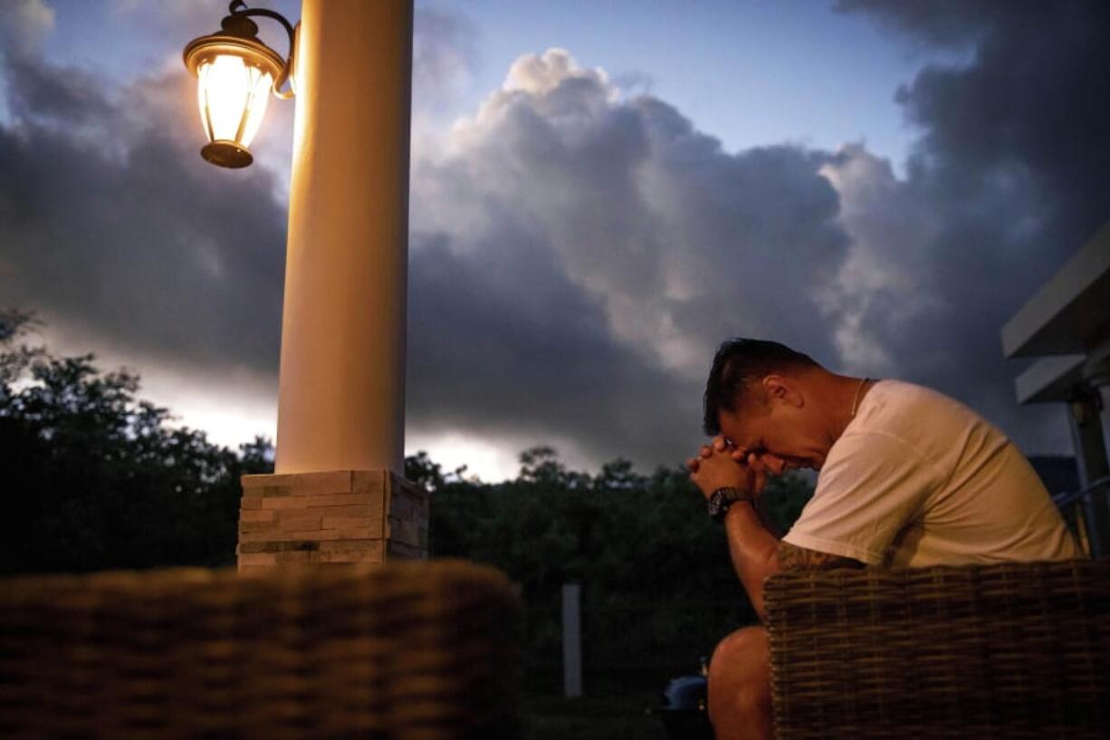 Walter Denton prays as the sun rises in his backyard in Agat, Guam, Saturday, May 11, 2019. Denton is one of over 200 former altar boys, students and Boy Scouts who are now suing Guam’s Catholic archdiocese over decades of sexual abuse they say they suffered at the hands of almost three dozen clergy, teachers and scoutmasters. “He took everything from me. From that day forward my demeanor changed. I break down, I hurt everyday and I still hurt,” said Denton. But, he adds, “he didn’t ruin my faith. I still believe in God.” Former Archbishop of Agana, Anthony Apuron denies the allegations.