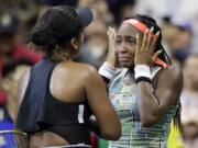 Coco Gauff wipes away tears while talking to Naomi Osaka, of Japan, after Osaka defeated Gauff during the third round of the U.S. Open tennis tournament Saturday, Aug. 31, 2019, in New York.