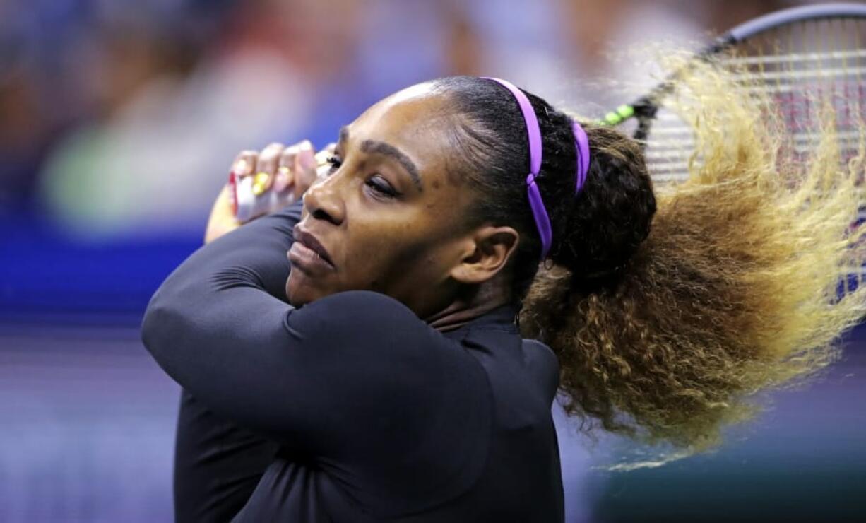 Serena Williams returns to Maria Sharapova during the first round of the U.S. Open tennis tournament in New York, Monday, Aug. 26, 2019.