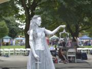 Jaime Brooks portrayed a living statue of Lady Justice at last year’s Peace and Justice Fair.