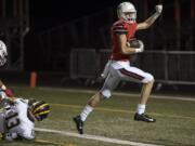 Camas’ Jackson Clemmer (83) breaks away from Bellevue defense to score a touchdown.