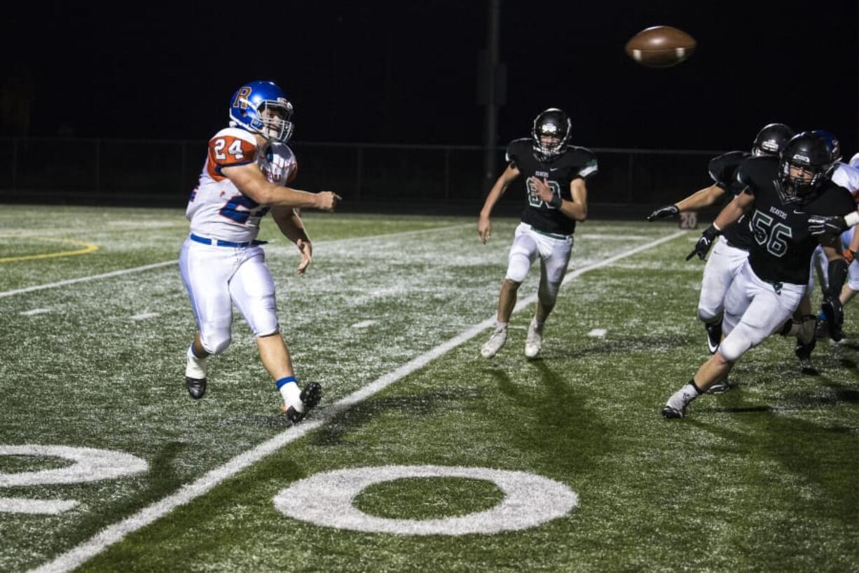 Ridgefield’s Hunter Abrams throws on a halfback pass last season against Woodland. The bruising back rushed for 1,000 yards and 10 touchdowns as a junior.