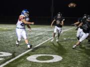 Ridgefield’s Hunter Abrams throws on a halfback pass last season against Woodland. The bruising back rushed for 1,000 yards and 10 touchdowns as a junior.