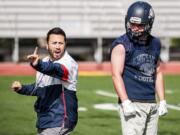 King’s Way Christian running back Connor Delamarter gets instruction from coach Brian Rodriguez.