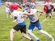 La Center receiver Andrew Scott tries to put a block on Sean Fox during a late-August practice.