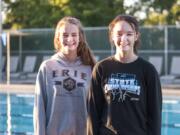 Camas senior Irelyne McGee, right, and junior Shealyne McGee stand by the pool at Cascade Athletic Club in Vancouver. The sisters make up two-thirds of the Camas dive team, which also includes junior Lili Ford.