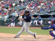 Seattle Mariners' Kyle Seager, left, connects for a three-run home run on a pitch from Texas Rangers reliever Taylor Guerrieri as catcher Jose Trevino, right, watches in the eighth inning of a baseball game in Arlington, Texas, Sunday, Sept. 1, 2019.