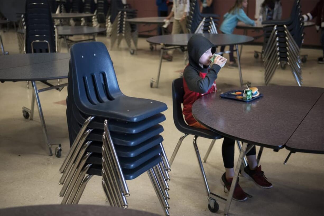 Fifth-grade student Daniel Casanova finishes his lunch in the mostly empty cafeteria of Chinook Elementary School in March after his fellow students left for recess. A state audit released last week found that elementary schools overwhelmingly are not providing children with enough time to eat their meals.