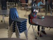 Fifth-grade student Daniel Casanova finishes his lunch in the mostly empty cafeteria of Chinook Elementary School in March after his fellow students left for recess. A state audit released last week found that elementary schools overwhelmingly are not providing children with enough time to eat their meals.