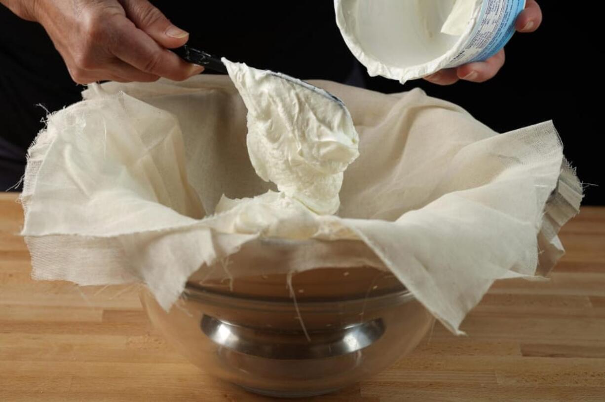 Spoon the yogurt into the cheesecloth.