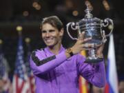 Rafael Nadal, of Spain, holds up the championship trophy after defeating Daniil Medvedev, of Russia, to win the men’s singles final of the U.S. Open tennis championships Sunday, Sept. 8, 2019, in New York.