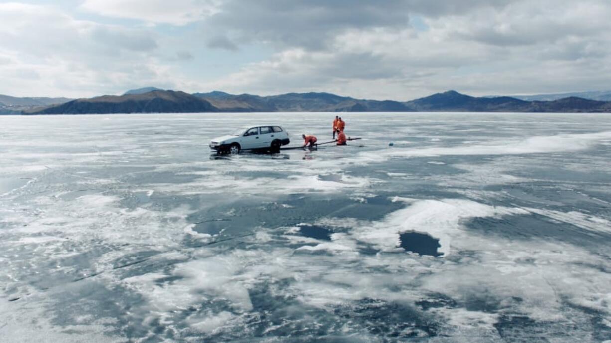 Police work to retrieve a car that had fallen through the ice of Lake Baikal in a scene from the film “Aquarela.” Sony Pictures Classics